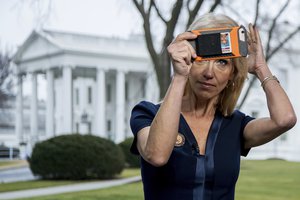 File - President Donald Trump's adviser Kellyanne Conway gets ready to go on television outside the White House, Sunday, Jan. 22, 2017, in Washington.