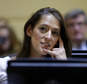 FILE - In this Jan. 3, 2017 file photo, Rhode Island state Rep. Moira Walsh, D-Providence, listens during swearing-in ceremonies in the House Chamber at the Statehouse in Providence, R.I. Walsh posted on Facebook Wednesday, Feb. 1, that she was fired the preceding week from her job as a waitress at the Classic Cafe. Owner Raymond Burns said he previously had warned Walsh that her vocal political discussions during her shift were interfering with her work. (AP Photo/Steven Senne, File)