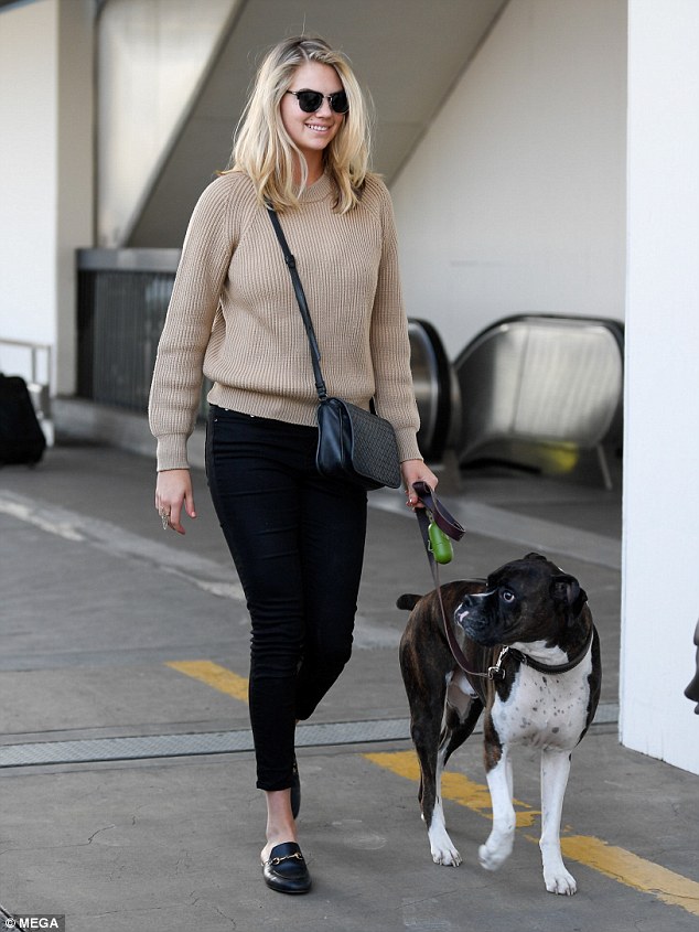 Chic: The 24-year-old model sported dark sunglasses and slip on black shoes, accessorising with a shoulder bag for her trip.