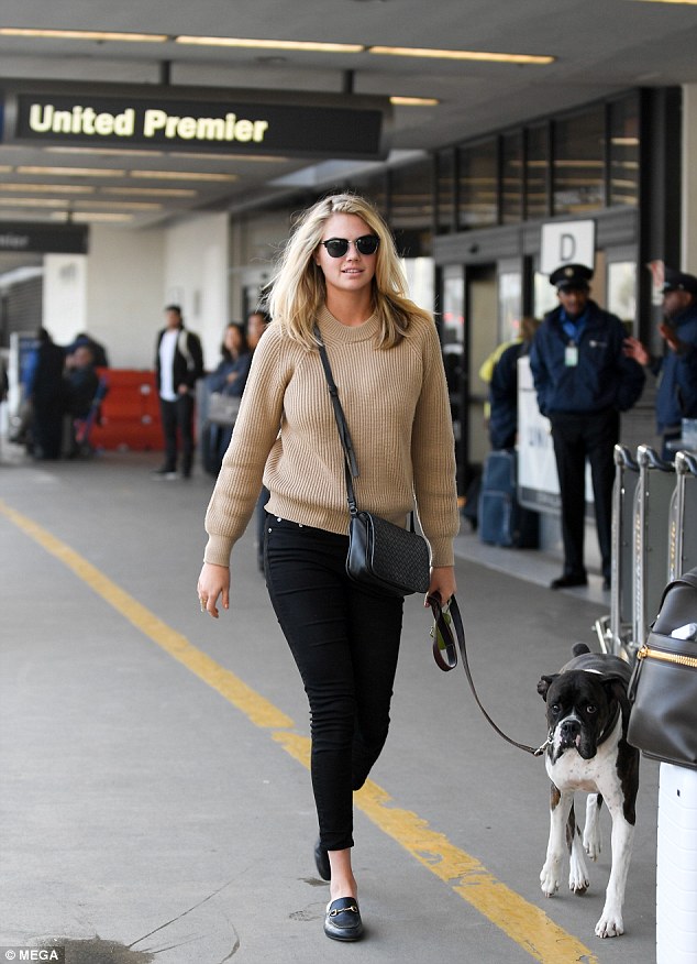 It's a dog's life: Kate Upton still looks glamorous in a sweater and jeans as she took her dog Harley to catch a flight out of LAX