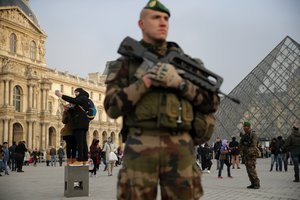 A soldier stands guard  outside the Louvre museum, in Paris, France