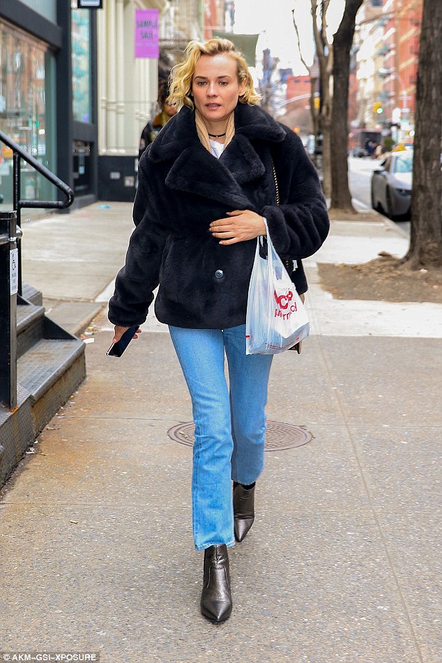 All business: This time the fashion model opted for light-wash denim with a bit of a flare at the ankle and a pointed-toe ankle bootie