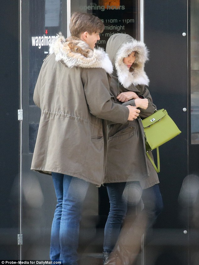 The two were all cozy together as they left the restaurant. The coats have rabbit fur on the detachable inner lining and a drawstring hood - pulled up by Deng - made of coyote.