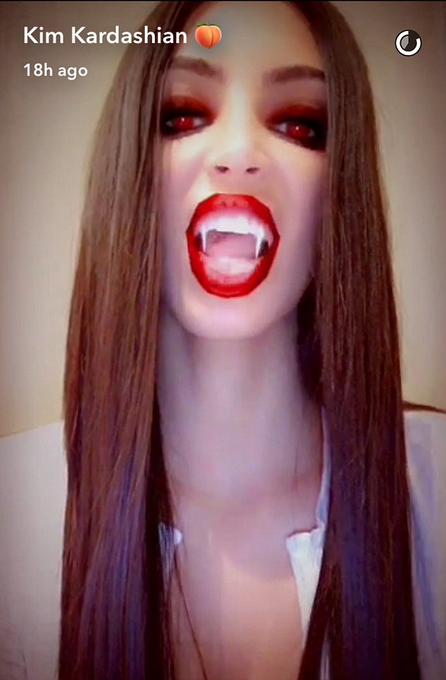 Kim gets her fangs out! Kardashian turns vampire as she plays around with new Snapchat feature on Friday