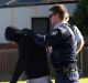 SYDNEY, AUSTRALIA - JUNE 09:  A man is searched by police officers during raids in Punchbowl on June 9, 2016 in Sydney, ...