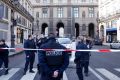 Police officers cordon off the area next to the Louvre after a soldier opened fire.