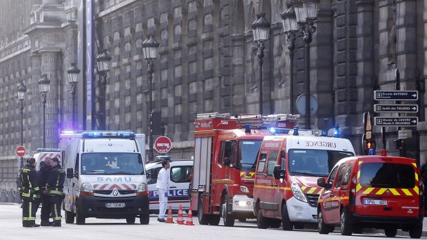 Rescue vans park carry outside the Louvre museum in Paris on Friday.