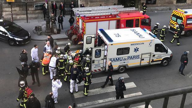 An unidentified wounded person is taken into an ambulance outside the Louvre in Paris on Friday.