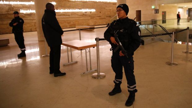 A police officer stands guard inside the Louvre Museum after the attack on Friday.