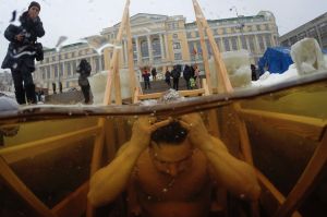 A Russian Orthodox believer swims in the icy water in a hole on Epiphany in the Neva River St.Petersburg.