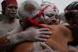 The Koomurri East Coast Sunrise ceremony people embrace Uncle Max (2nd from left) after the WugulOra Australia Day ...