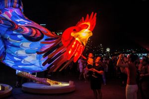 SYDNEY, AUSTRALIA - JANUARY 27: Jeffery Tor, shows his son Kobi the giant snake rooster installation, next to the Sydney ...