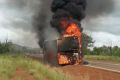 The school bus engulfed in flames.