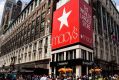 Pedestrians and shoppers pass in front of a Macy's flagship store in New York.