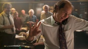 Matthew McConaughey, as Kenny Wells, looks for investors by phone in a Las Vegas bar. There's nothing but grit to cling ...