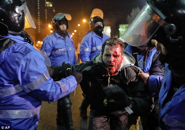 Romanian riot police detain a man after clashes erupted during a protest in Bucharest this week. But many fears the world is going to Hell in a handcart