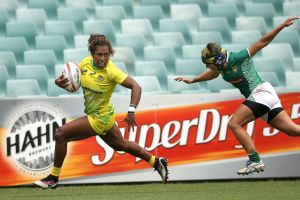 Australia's Ellia Green, left, out paces Brazil's Luiza Campos to score a try during their match at the World Rugby ...