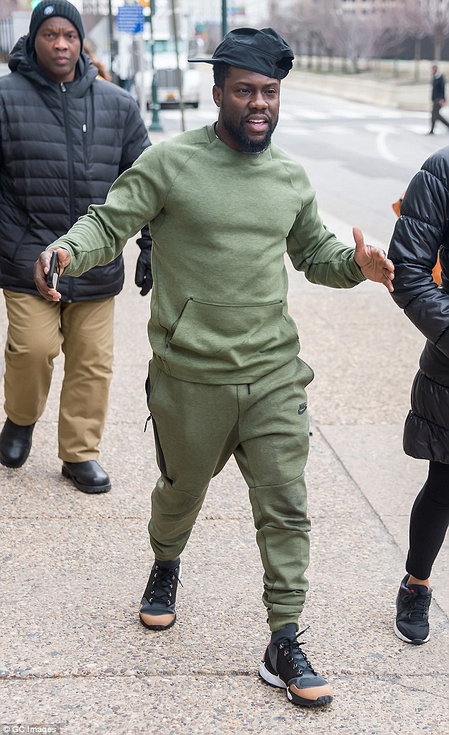 Monochromatic: Hart opted for an olive green track suit and black pumps to arrive on set