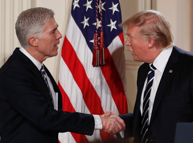 President Donald Trump shakes hands with newly appointed Supreme Court Judge Neil Gorsuch.