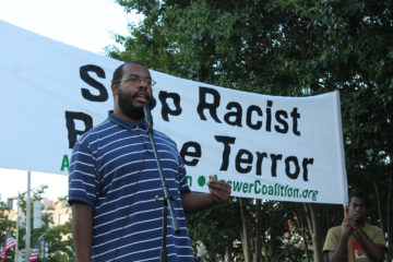 Eugene Puryear speaks at the one year anniversary of the killing of Mike Brown by police officer Darren Wilson. Photo by Elvert Brown.