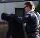 SYDNEY, AUSTRALIA - JUNE 09:  A man is searched by police officers during raids in Punchbowl on June 9, 2016 in Sydney, ...