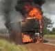 The school bus engulfed in flames.