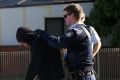 SYDNEY, AUSTRALIA - JUNE 09:  A man is searched by police officers during raids in Punchbowl on June 9, 2016 in Sydney, ...