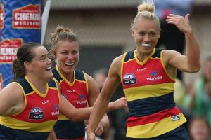 Erin Phillips of the Crows (second from right) celebrates a goal.