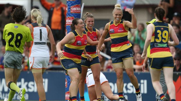 Erin Phillips of the Crows (second from right) celebrates a goal.