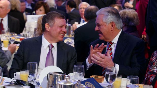 Jordan's King Abdullah, left, talks with US Secretary of State Rex Tillerson during the National Prayer Breakfast, on ...