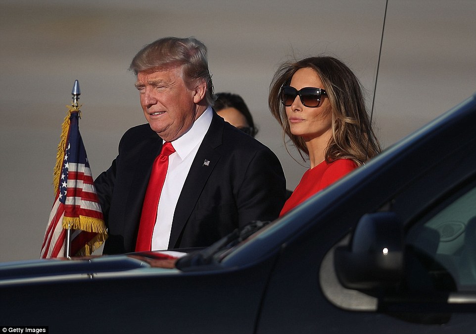 NEXT STOP MAR-A-LAGO: President Donald Trump walks with his wife Melania Trump on the tarmac after he arrived on Air Force One at the Palm Beach International Airport for a visit to his Mar-a-Lago Resort for the weekend