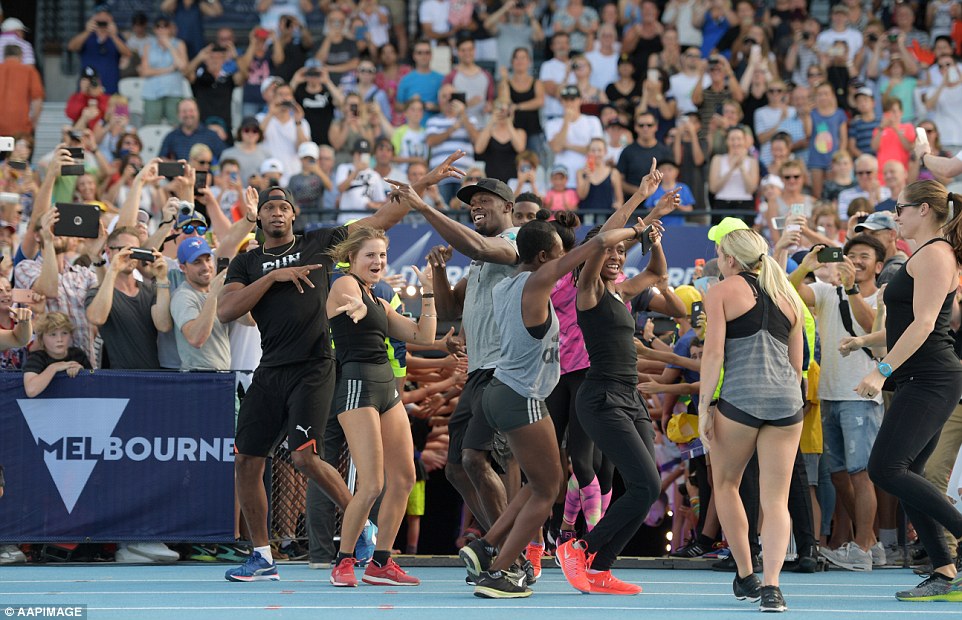 Jamaican sprinters Usain Bolt (centre) and Asafa Powell (left) run onto the field at the start of the Nitro Athletics series at Lakeside Stadium in Melbourne on Saturday 