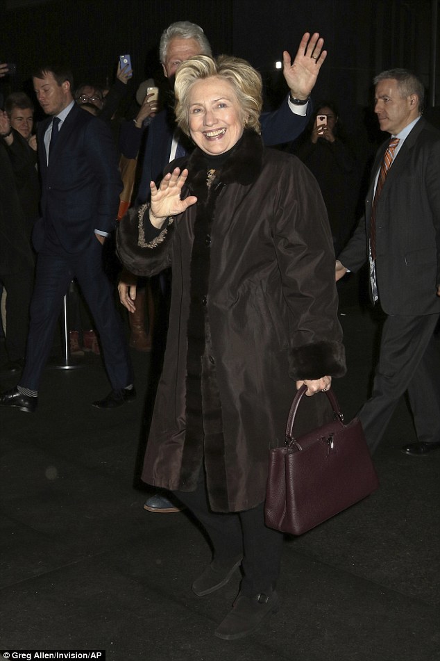 Happy: Hillary kept it casual in her clothing choice as she sported black pants with a brown heavy coat. However, the former first lady did carry a pricey Louis Vuitton burgundy colored leather handbag that has a starting price tag of around $6,000