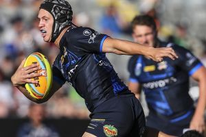 Star on the rise: Kalyn Ponga looks to break the tackle of Paul Roache on day one of the Auckland Nines.