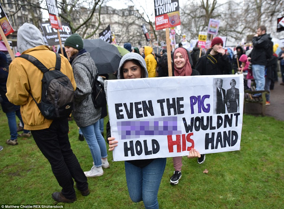 Protesters displayed their disquiet at Theresa May for holding the President's hand on her recent visit to Washington