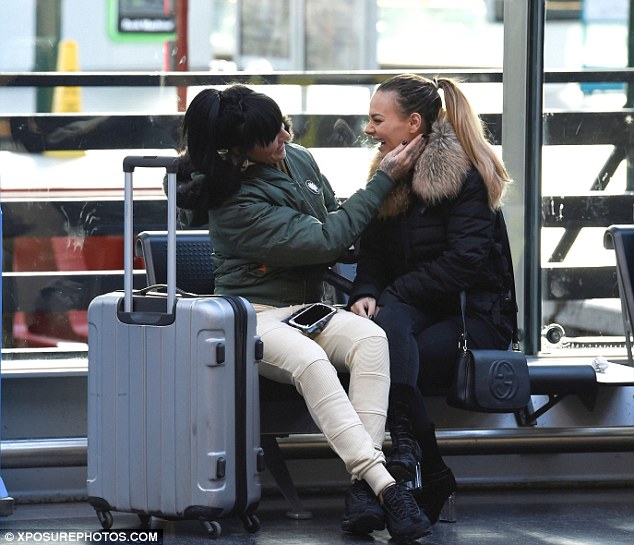 Happy: Chantelle looked chic in an all black look as she donned a puffa jacket with faux fur collar with her black skinny denims, Gucci bag and velvet calf high boots