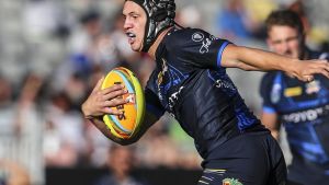 Star on the rise: Kalyn Ponga looks to break the tackle of Paul Roache on day one of the Auckland Nines.