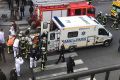 One of the wounded is taken into an ambulance outside the Louvre in Paris.