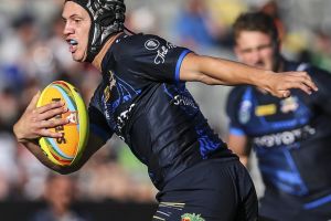 Star on the rise: Kalyn Ponga looks to break the tackle of Paul Roache on day one of the Auckland Nines.