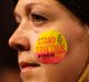 A demonstrator takes part in a protest against US President Donald Trump's controversial travel ban in London.