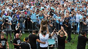 SYDNEY, AUSTRALIA - OCTOBER 03:  The Cronulla Sharks hold up the NRL trophy and meet the fans at their home ground shark ...