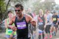 Runners get water relief at The Sydney Morning Herald Sun Run on Saturday.