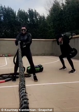 Tough: Kourtney and Khloe did crunches and also worked with ropes for their Saturday session