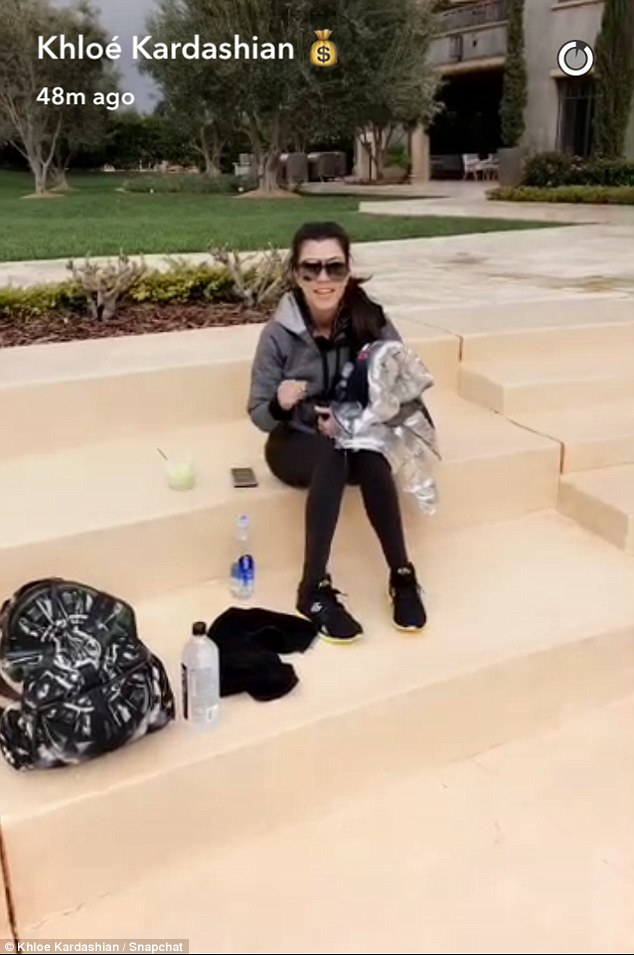 Resting: Khloe even filmed Kourtney when she arrived, calling her 'late' for theirworkout