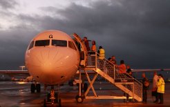 Bust  in  the  Pilbara. Image of mining workers flying from Perth