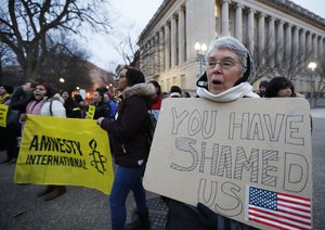 Kathleen Dorman of Tacoma Park, Md., joins a rally protesting the immigration policies of President Donald Trump, near the White House in Washington, Friday, Feb. 3, 2017.