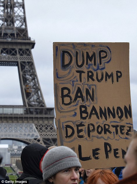 People carry signs at a protest in Paris