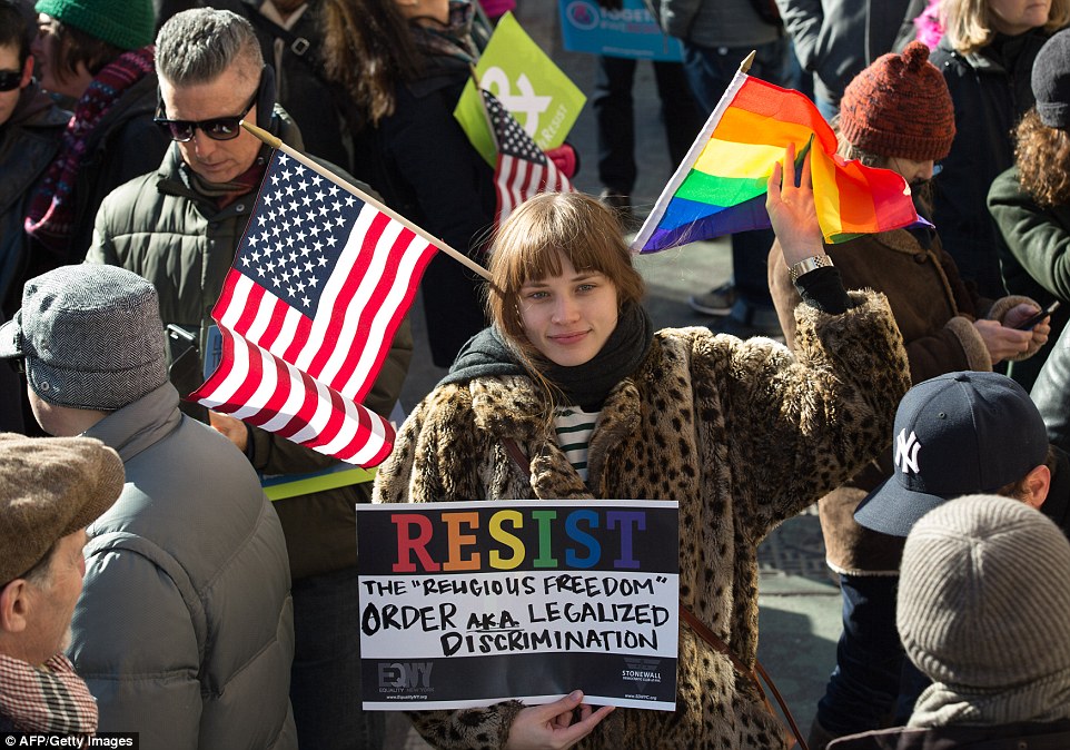 People protest against President Trump and his cabinet and the threat that they will take away LGBTQ rights