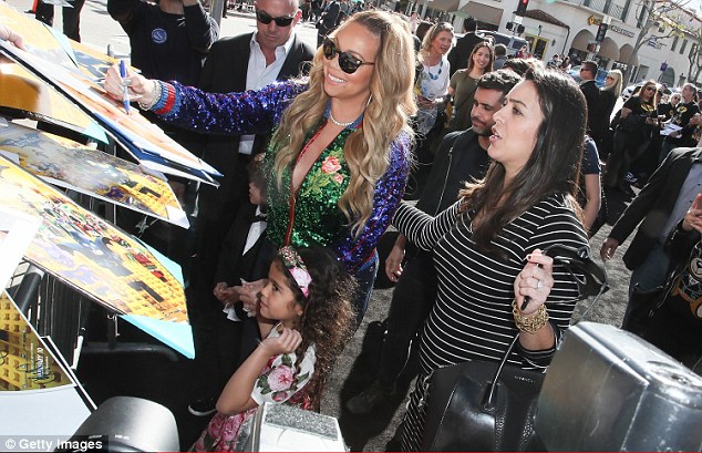 For her fans: Mariah was seen signing autographs while keeping her kids close by