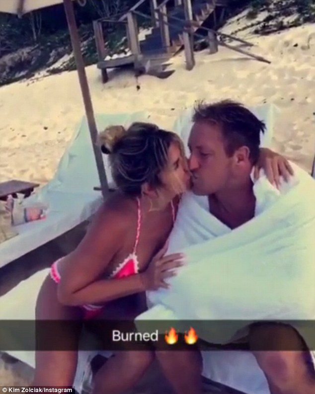 Kisses! Kim Zolciak turned up the heat as she enjoyed a beach day with husband Kroy Biermann. She shared an Instagram video of the couple on Saturday